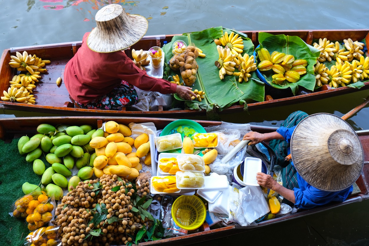 a food vendor at a floating market in Thailand