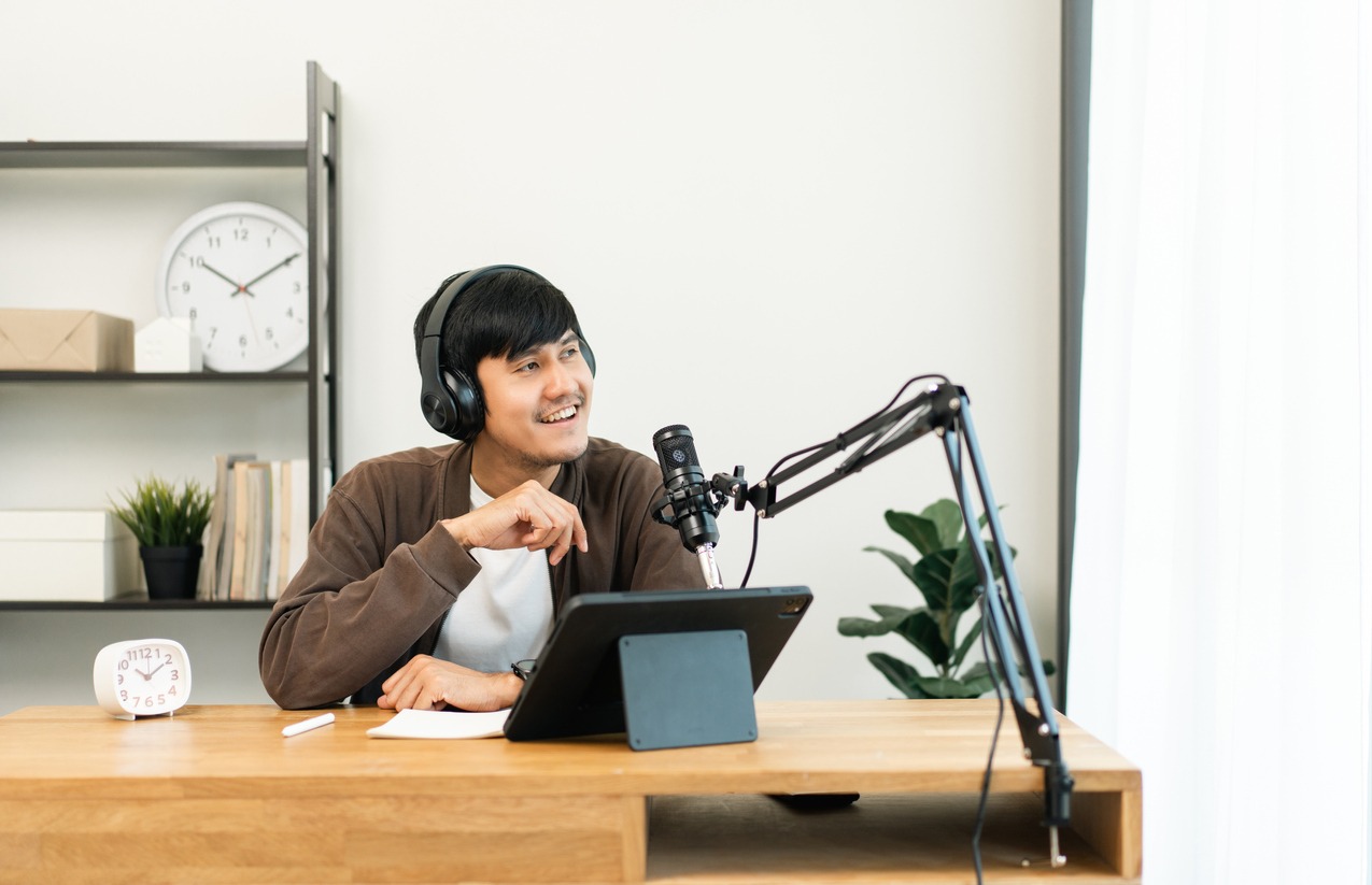 a man recording a podcast at a home studio