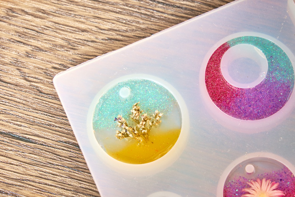 a resin mold with colorful resin art to be used as a pendant and earring