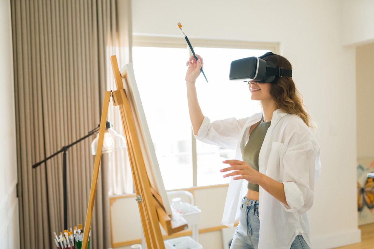 a woman using VR glasses and creating a painting 