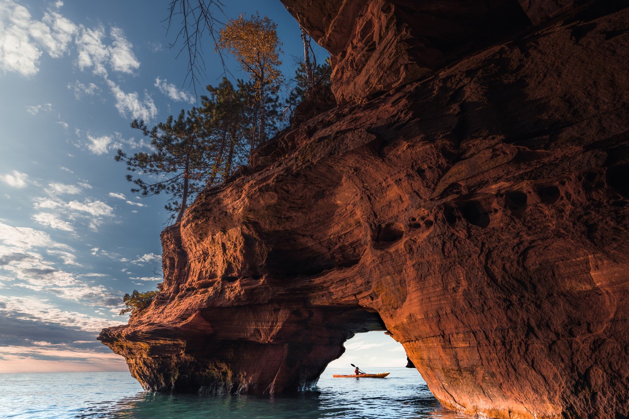 one kayaker exits a sea cave on The Apostle Island National Lakeshore