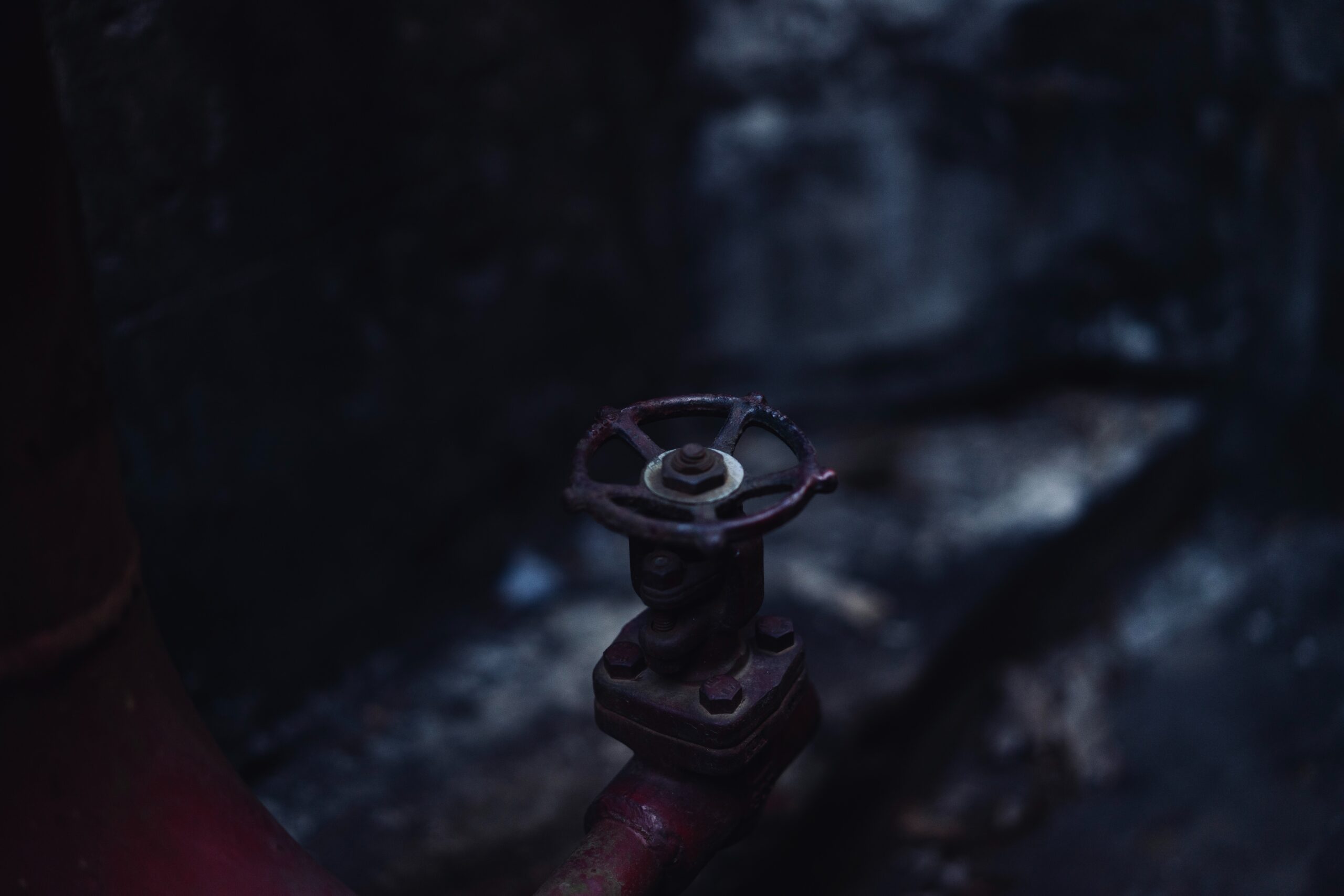a-close-up-of-a-pipe-with-a-rusted-valve
