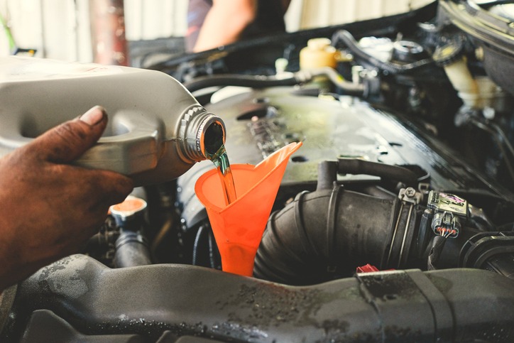 car-service-car-technician-pouring-the-fresh-transmission-oil-at-the-car-service