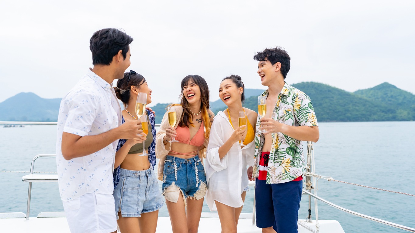 group-of-asian-people-drinking-champagne-on-luxury-catamaran-boat-sailing