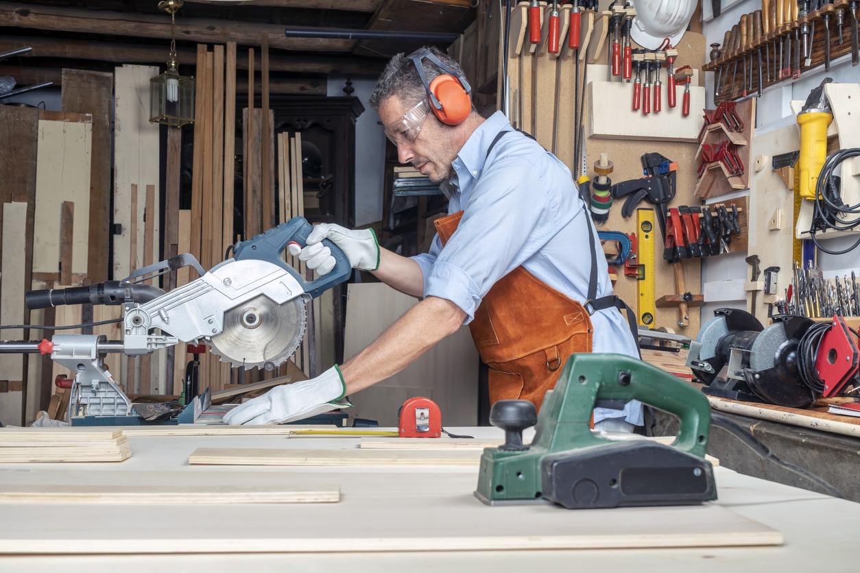 carpenter-in-the-workshop-working-wood-using-a-miter-saw-diy-concept