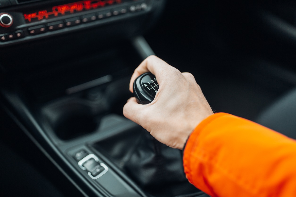 mans-hand-switches-manual-transmission-closeup