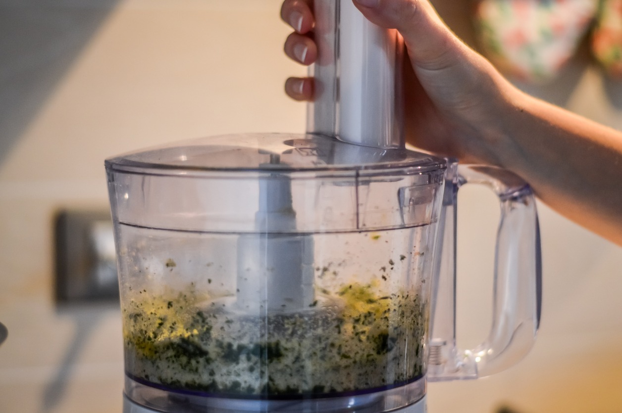 parsley-and-bread-crumbs-on-electric-blender-bowl-close-up