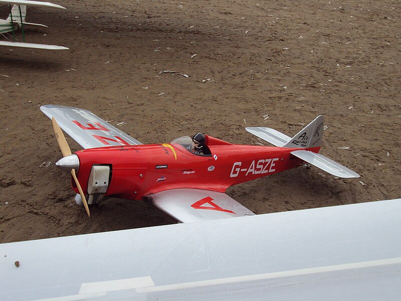 red model aircraft with pilot