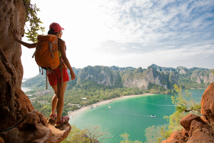 young-woman-backpacker-hiking-on-seaside-mountain