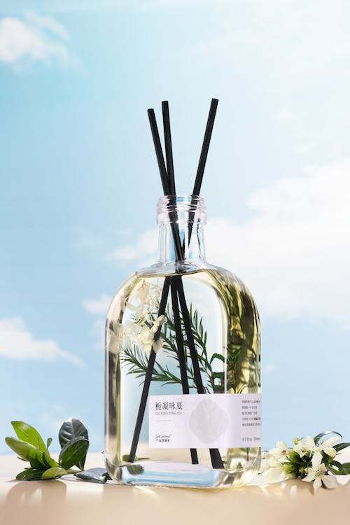 Incense sticks in a glass bottle with a fragrance oil