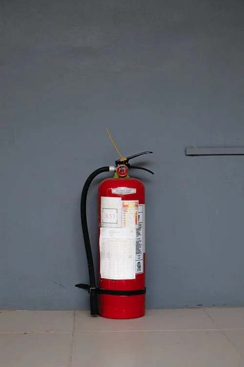 Red fire extinguisher against wall